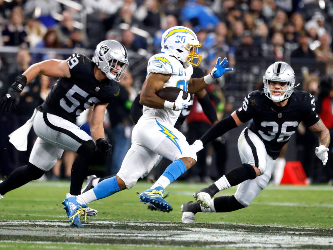 Raiders linebacker Luke Masterson (59) and linebacker Curtis Bolton (36) chase Los Angeles Char ...