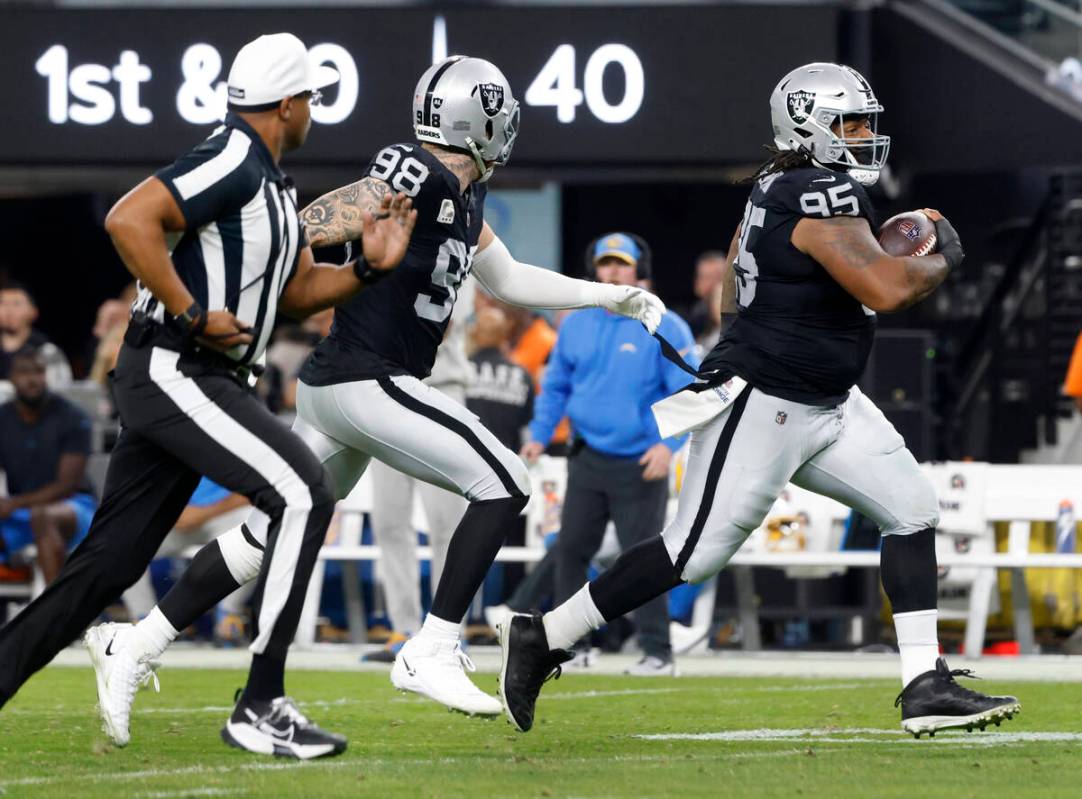 Raiders defensive tackle John Jenkins (95) runs for a touchdown after recovering a fumble durin ...