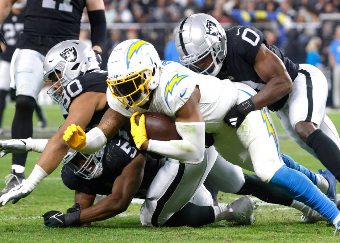 Los Angeles Chargers tight end Gerald Everett (7) is taken down by Raiders defense during the s ...