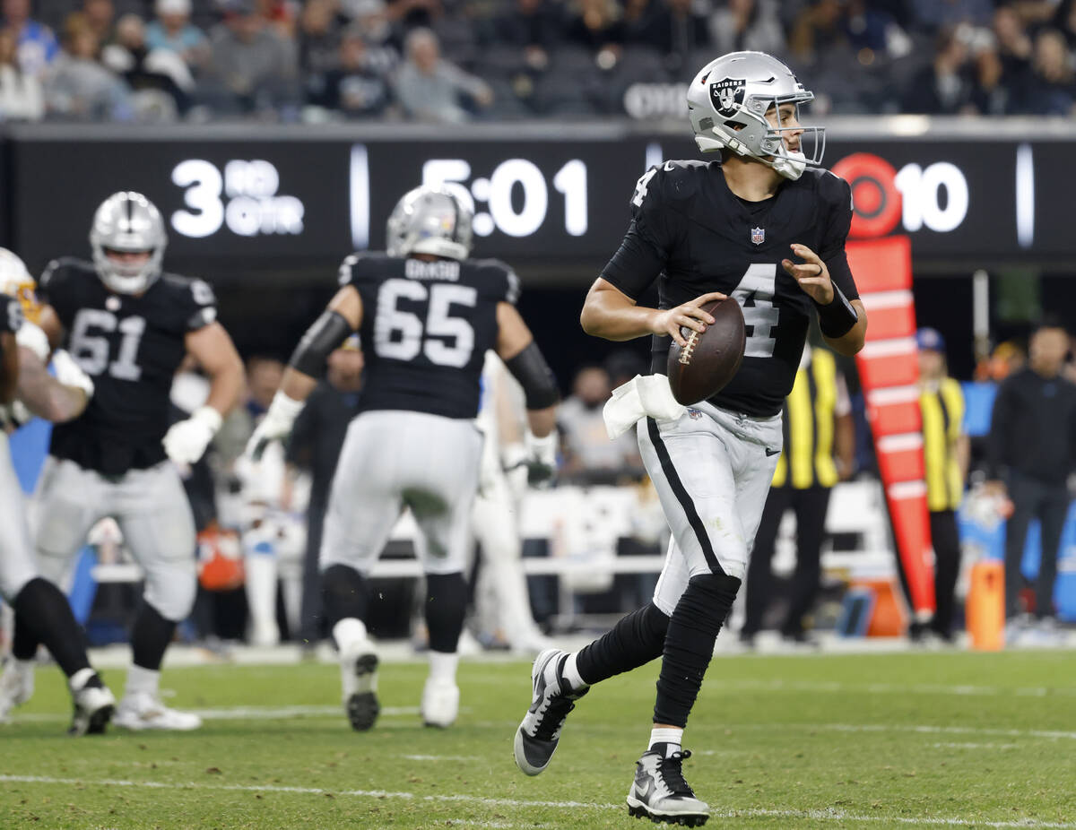 Raiders quarterback Aidan O'Connell (4) prepares to throw a pass against Los Angeles Chargers d ...