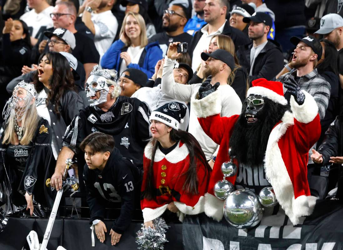 Raiders fans cheer for their team during the second half of an NFL football game against Los An ...