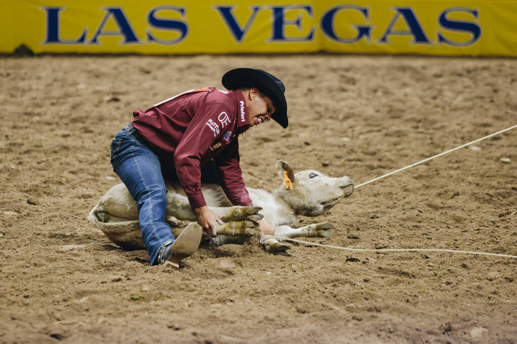 Shad Mayfield ties the calf during tie down roping at the National Finals Rodeo at the Thomas & ...