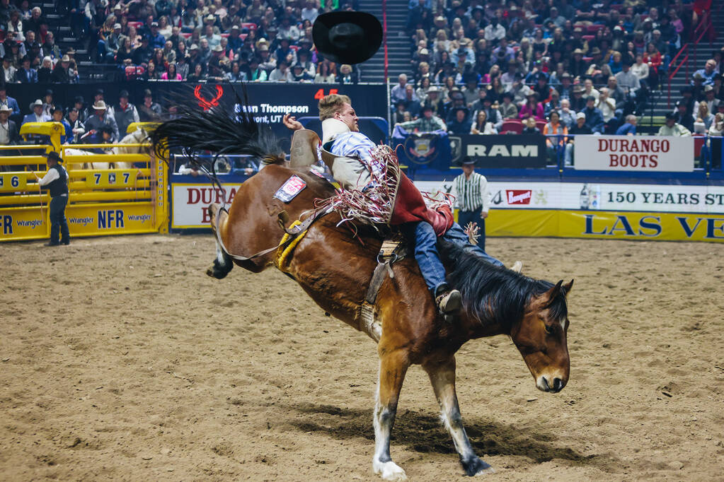 Dean Thompson loses his hat during his bareback bronc ride at the National Finals Rodeo at the ...