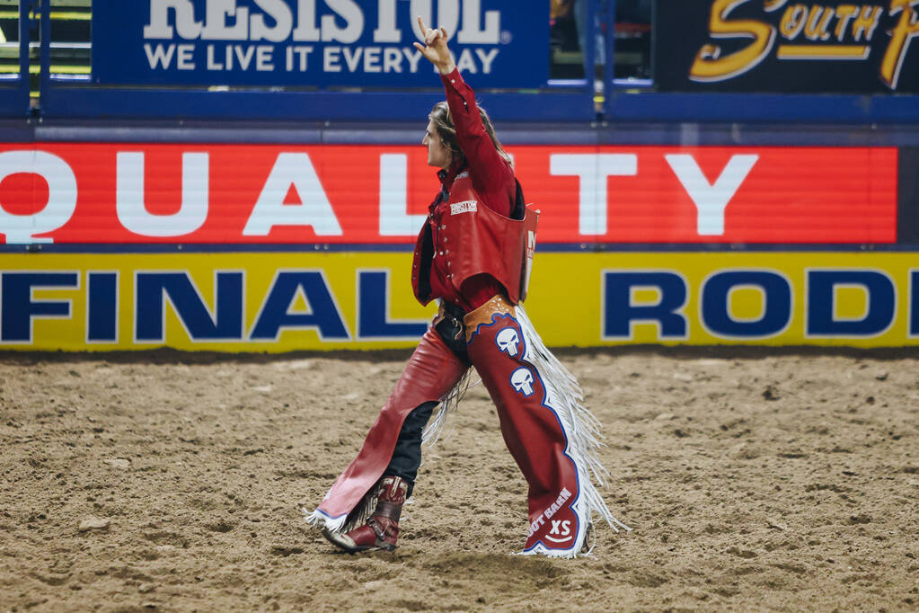 Rocker Steiner puts his hand in the air after his ride during the National Finals Rodeo at the ...