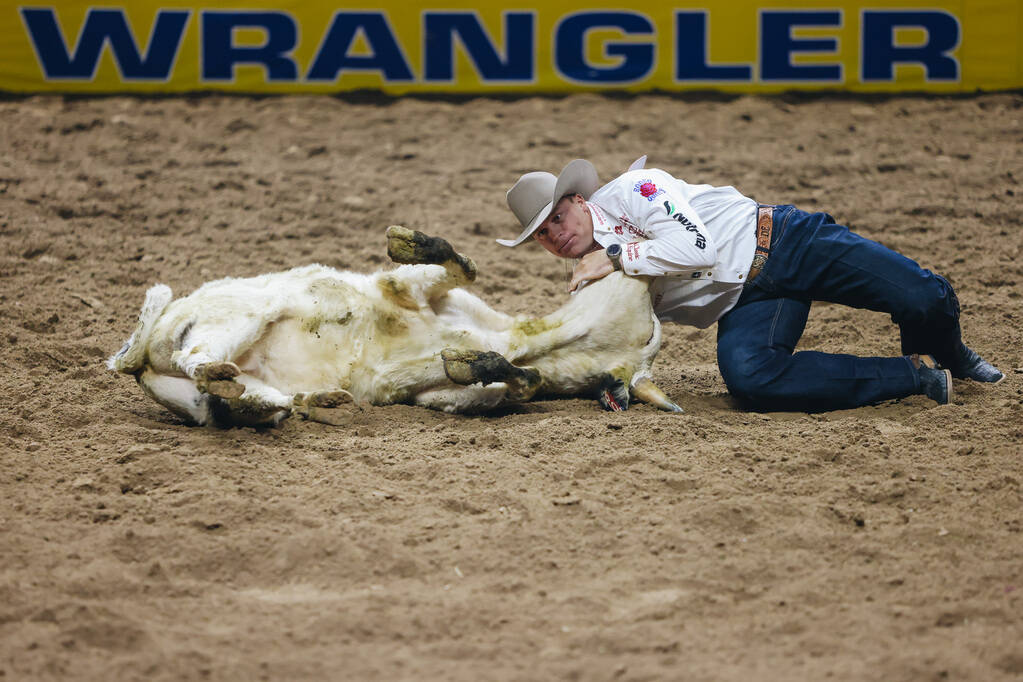 Dakota Eldridge wrestles the steer during the National Finals Rodeo at the Thomas & Mack Ce ...