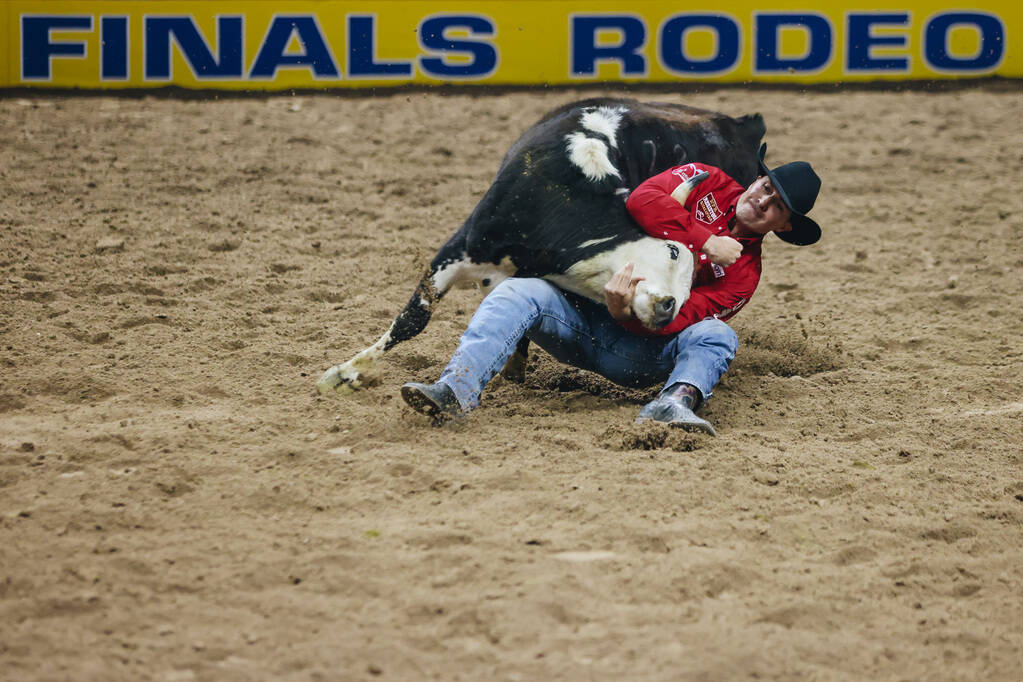 Jesse Brown wrestles the steer during the National Finals Rodeo at the Thomas & Mack Center ...