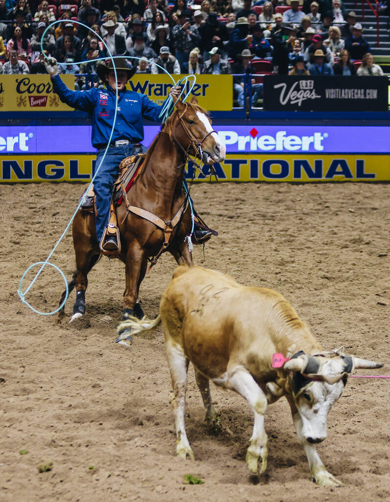 Cole Curry reacts as he misses roping the back leg of the calf during the National Finals Rodeo ...
