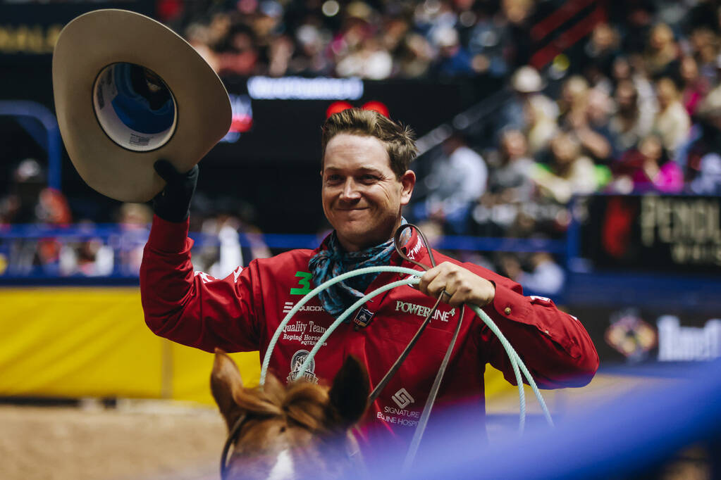 Buddy Hawkins II gestures top the crowd after his turn at team roping during the National Final ...