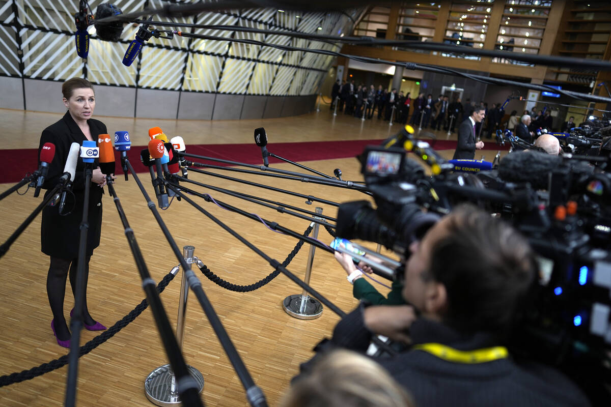 Denmark's Prime Minister Mette Frederiksen speaks with the media as she arrives for an EU summi ...