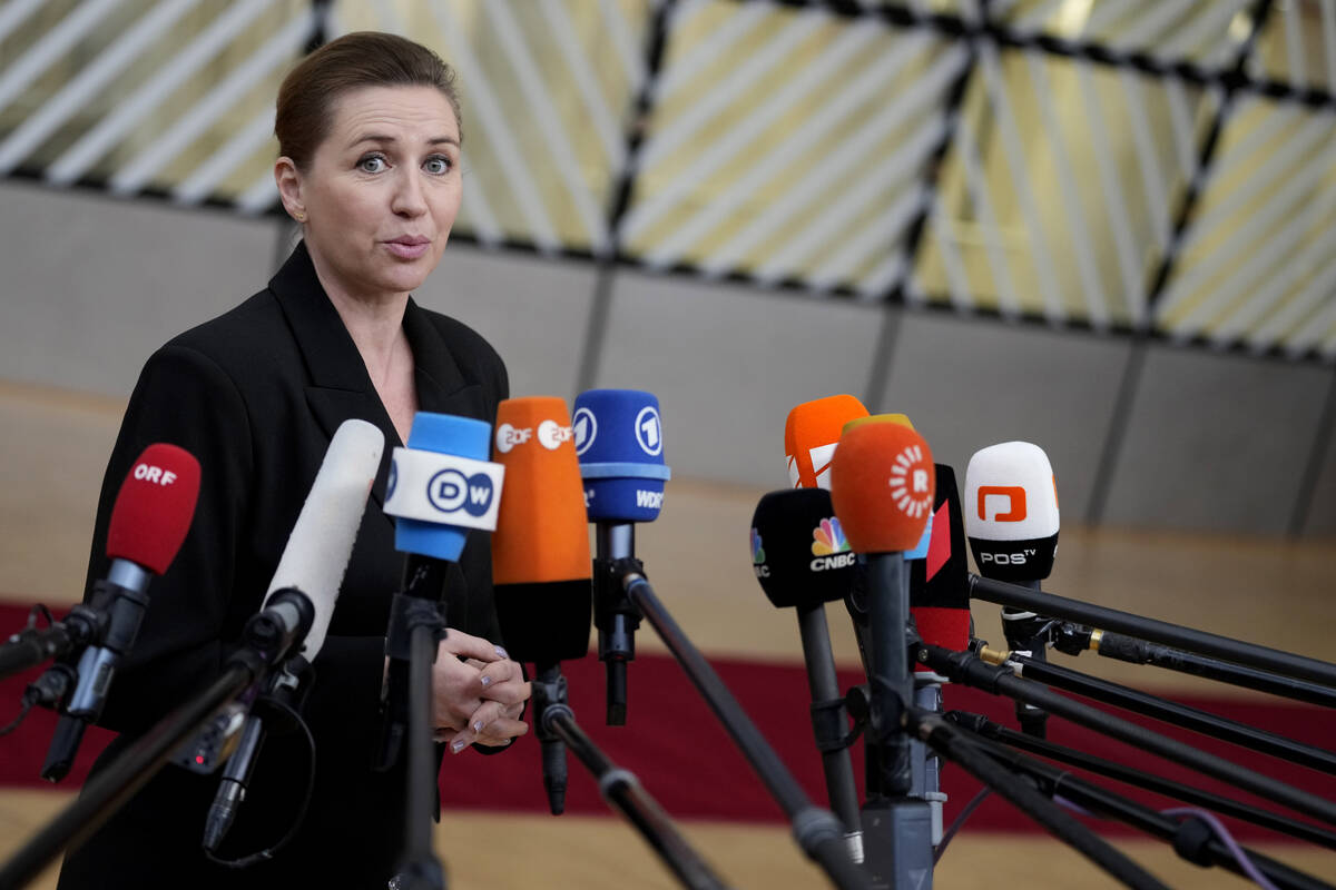 Denmark's Prime Minister Mette Frederiksen speaks with the media as she arrives for an EU summi ...