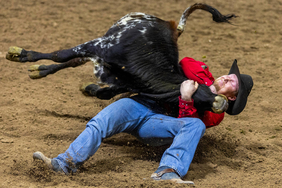 Cody Devers takes down a calf during day 6 action of the NFR at the Thomas & Mack Center on ...