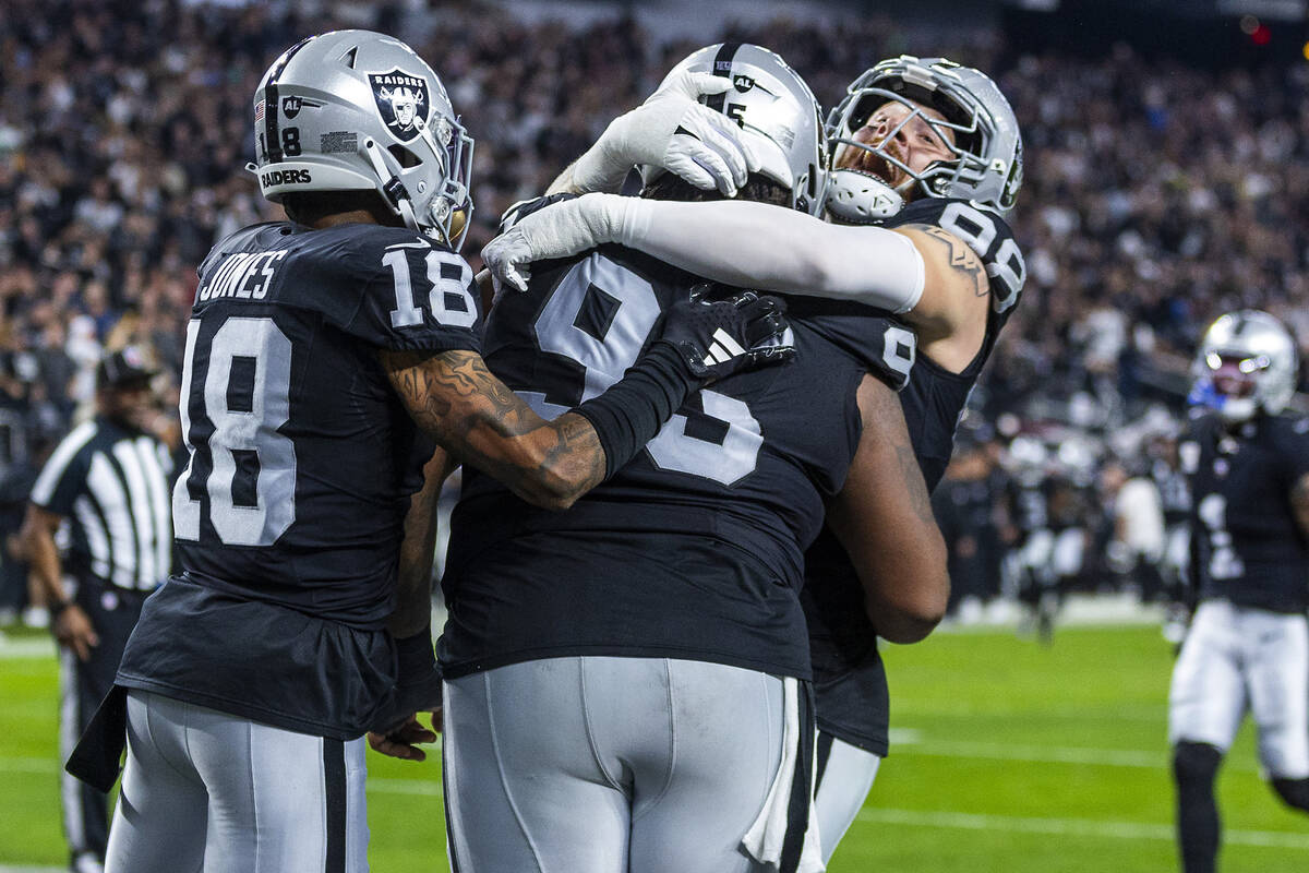 Raiders defensive tackle John Jenkins (95) celebrates a touchdown with defensive end Maxx Crosb ...