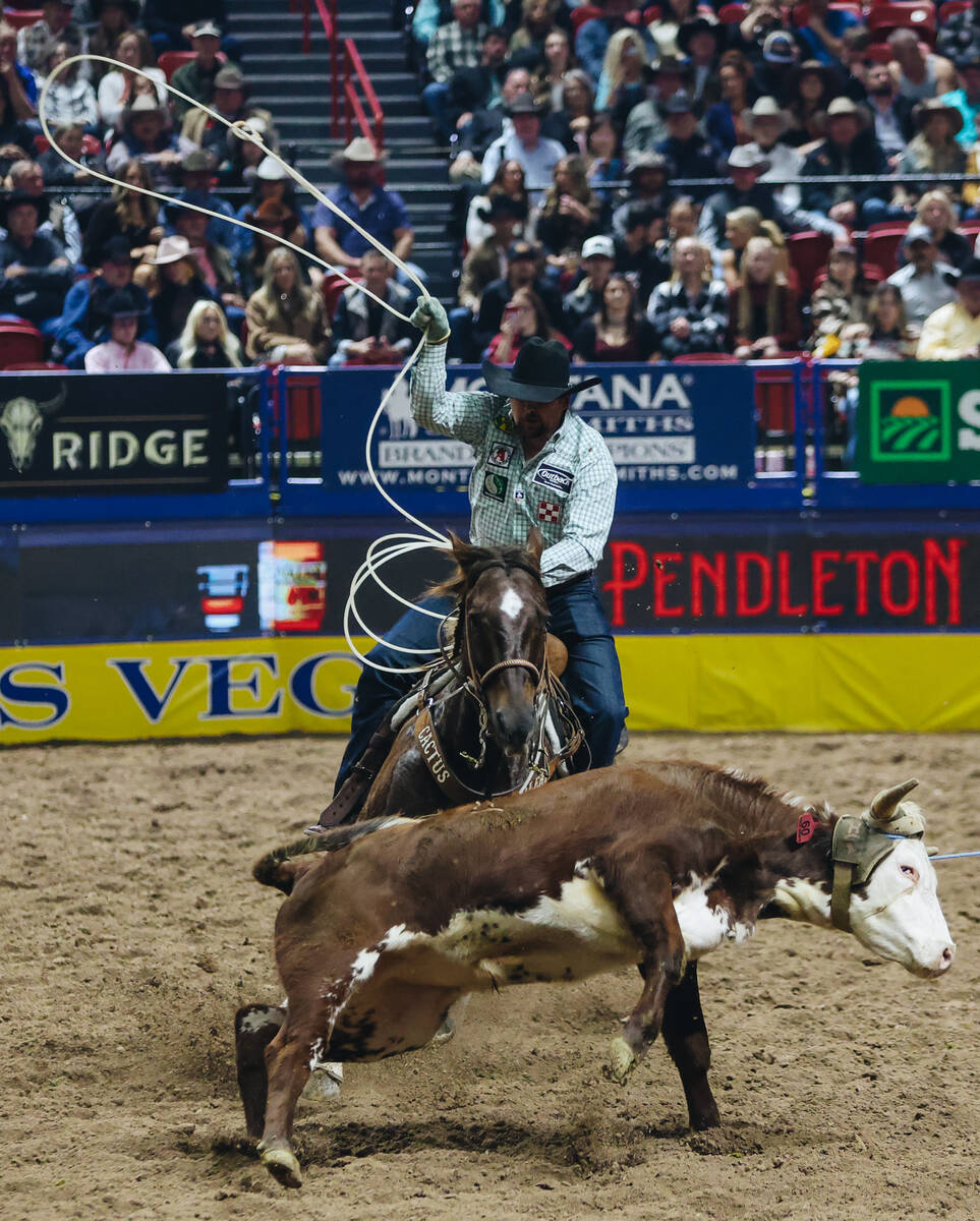 Jake Long ropes the calf during the National Finals Rodeo at the Thomas & Mack Center on Fr ...