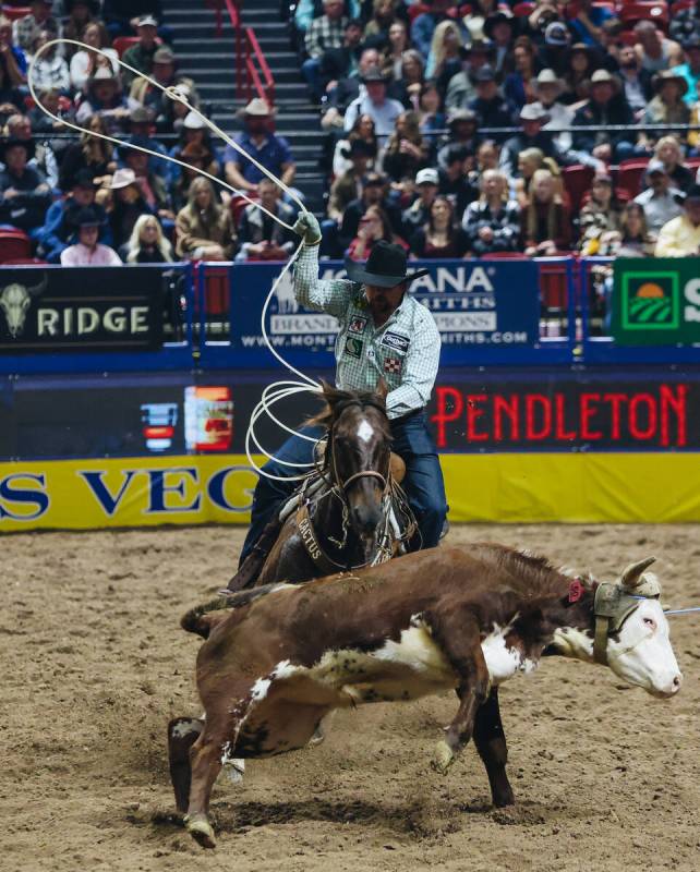 Jake Long ropes the calf during the National Finals Rodeo at the Thomas & Mack Center on Fr ...
