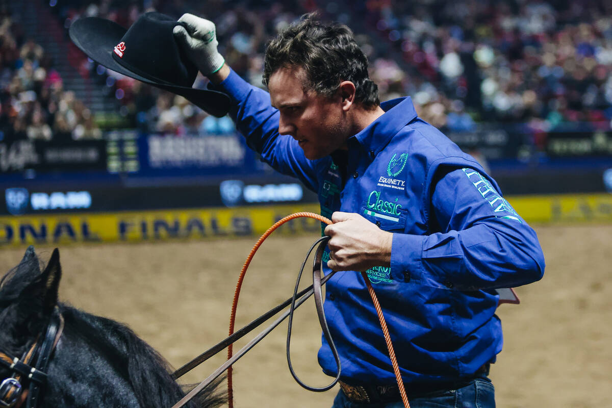 Wesley Thorp celebrates taking first place in team roping during the National Finals Rodeo at t ...