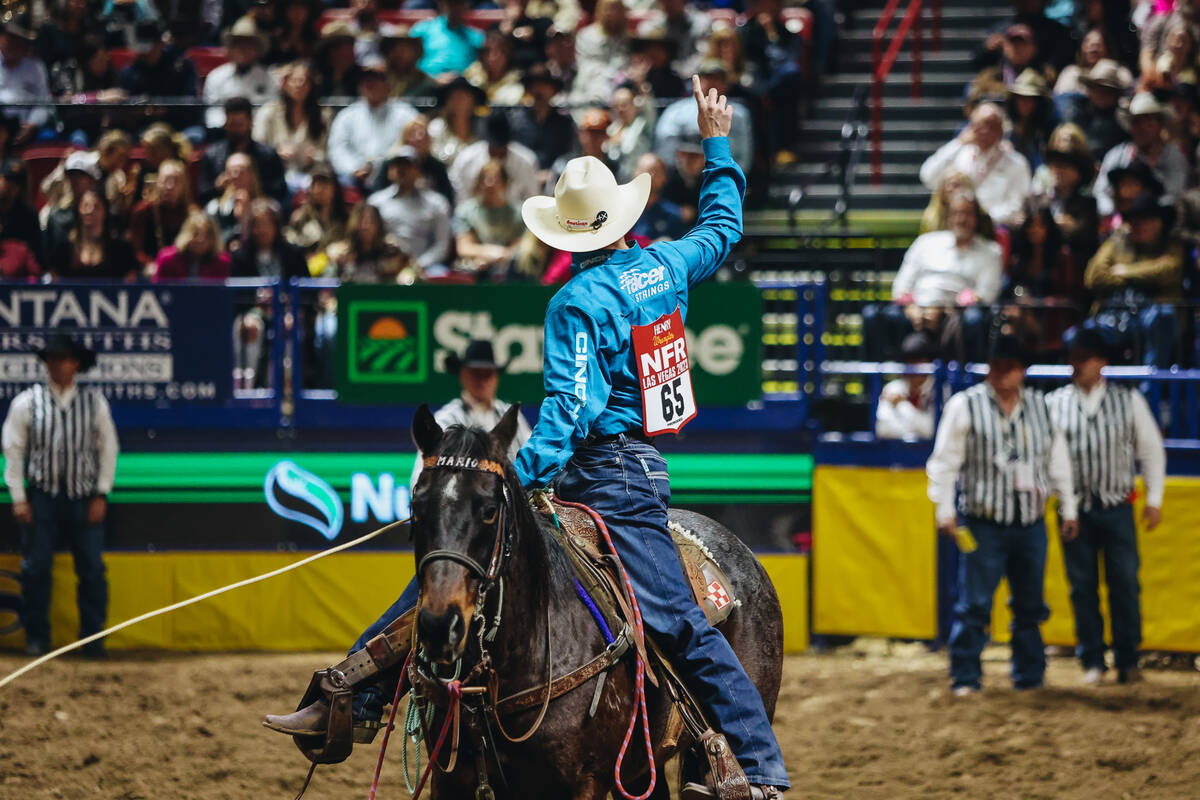 Kincade Henry signals to the crowd during the National Finals Rodeo at the Thomas & Mack Ce ...