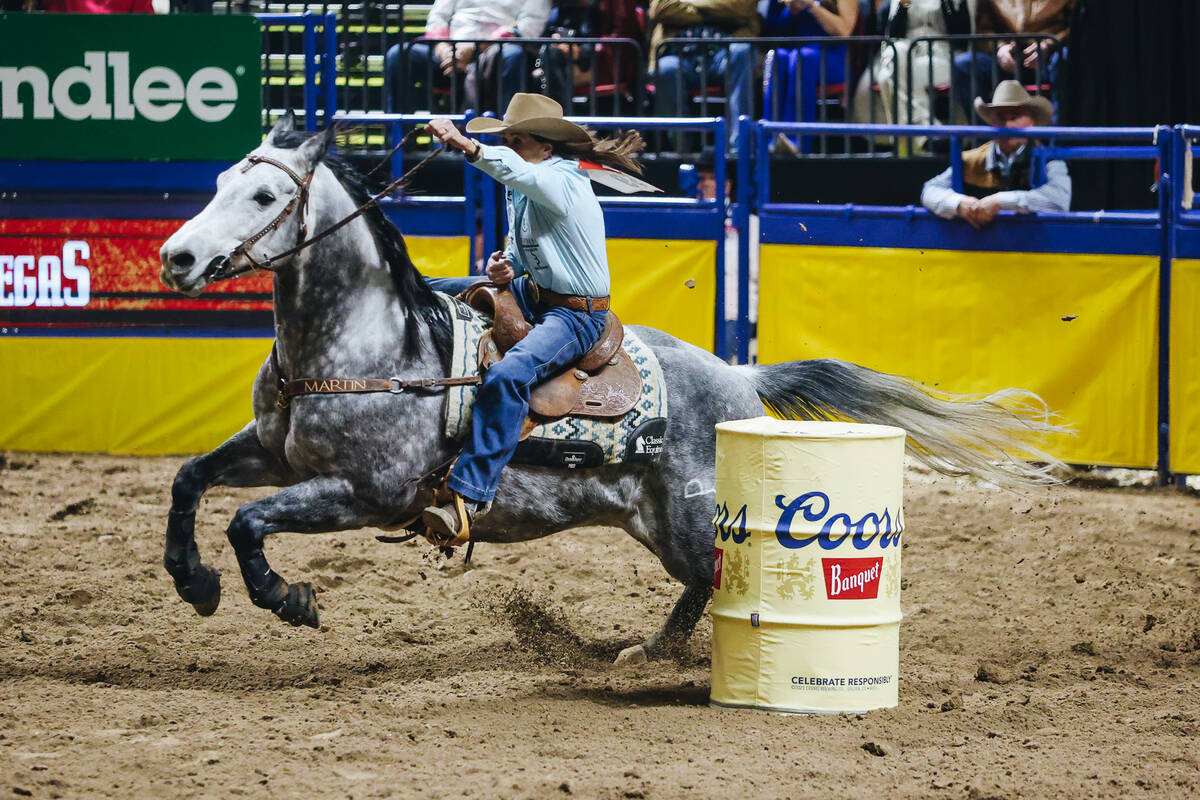Lisa Lockhart races her horse during the barrel racing portion of the National Finals Rodeo at ...