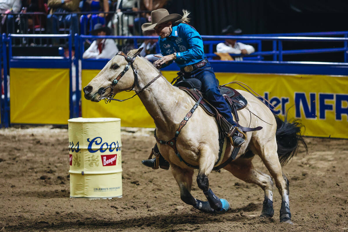 Sue Smith races her horse during the barrel racing portion of the National Finals Rodeo at the ...