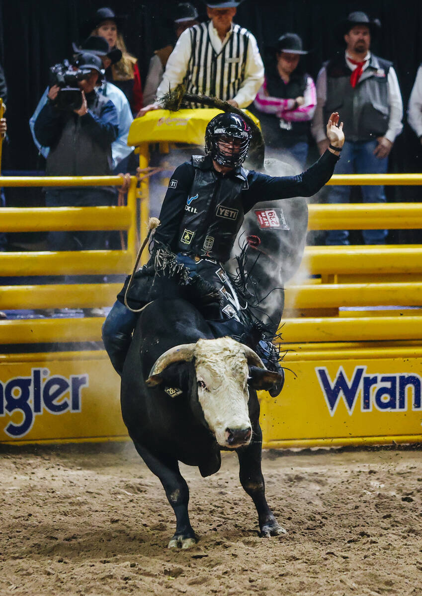 Cody Teel rides the bull during the National Finals Rodeo at the Thomas & Mack Center on Fr ...