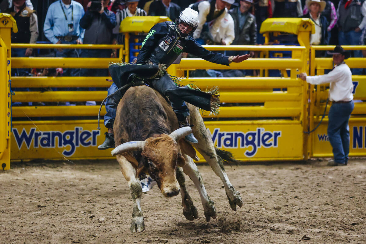 T Parker rides the bull during the National Finals Rodeo at the Thomas & Mack Center on Fri ...