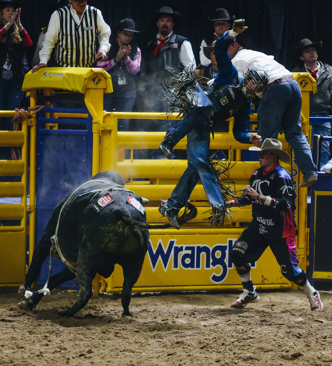 Jeff Askey falls off the bull during the National Finals Rodeo at the Thomas & Mack Center ...