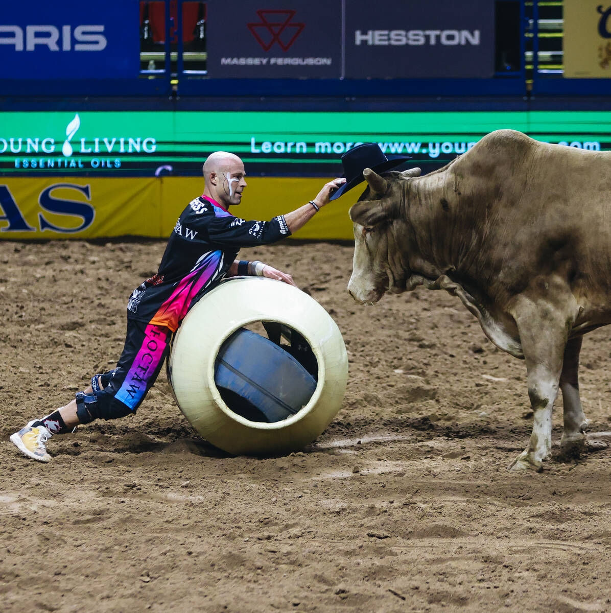 Bullfighter Dusty Tuckness offers his hat to one of the bulls after Josh Frost’s ride du ...