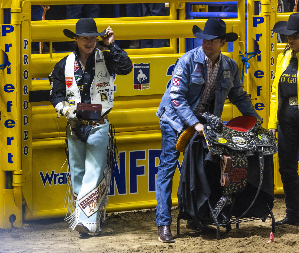 Keenan Hayes celebrates his PRCA World Championship with an award and saddle in Bareback Riding ...