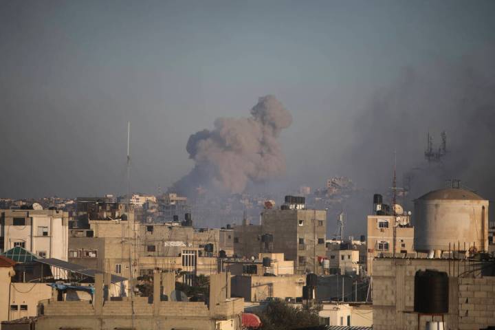 Smoke rises from town of Khan Younis after Israeli strikes on Friday, Dec. 15, 2023. (AP Photo/ ...