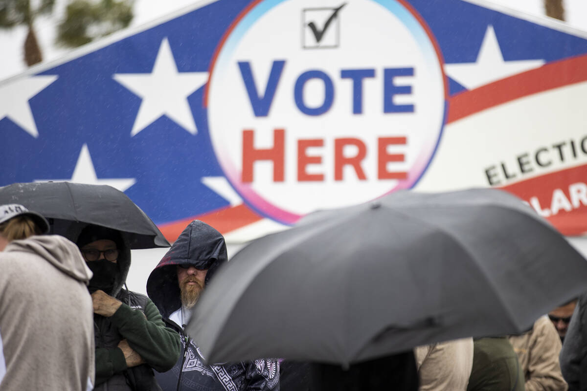 People wait in line to cast their vote at the Centennial Center polling place in Las Vegas, Tue ...