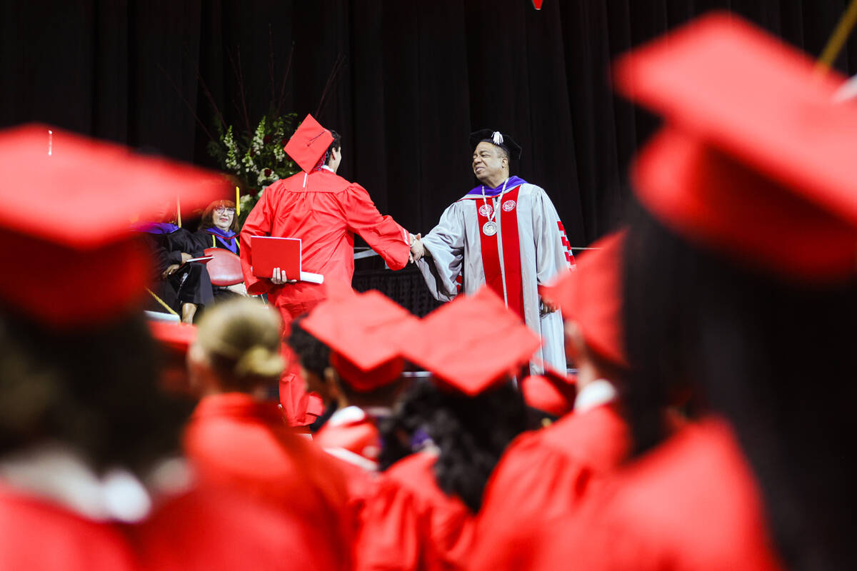 UNLV President Keith Whitfield shakes hands with a graduate at the college’s winter comm ...