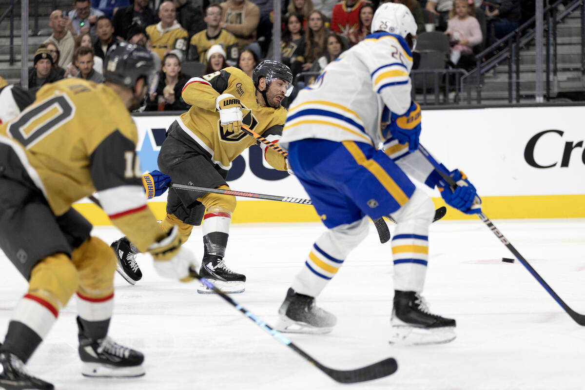 Golden Knights left wing William Carrier (28) shoots against Sabres defenseman Owen Power (25) ...