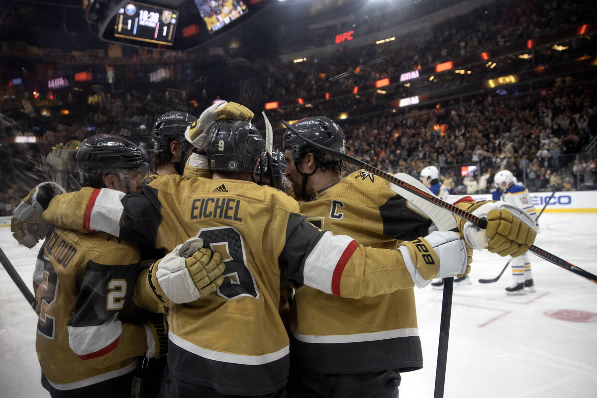 The Golden Knights rally around center Jack Eichel (9) after he scored against the Sabres, his ...