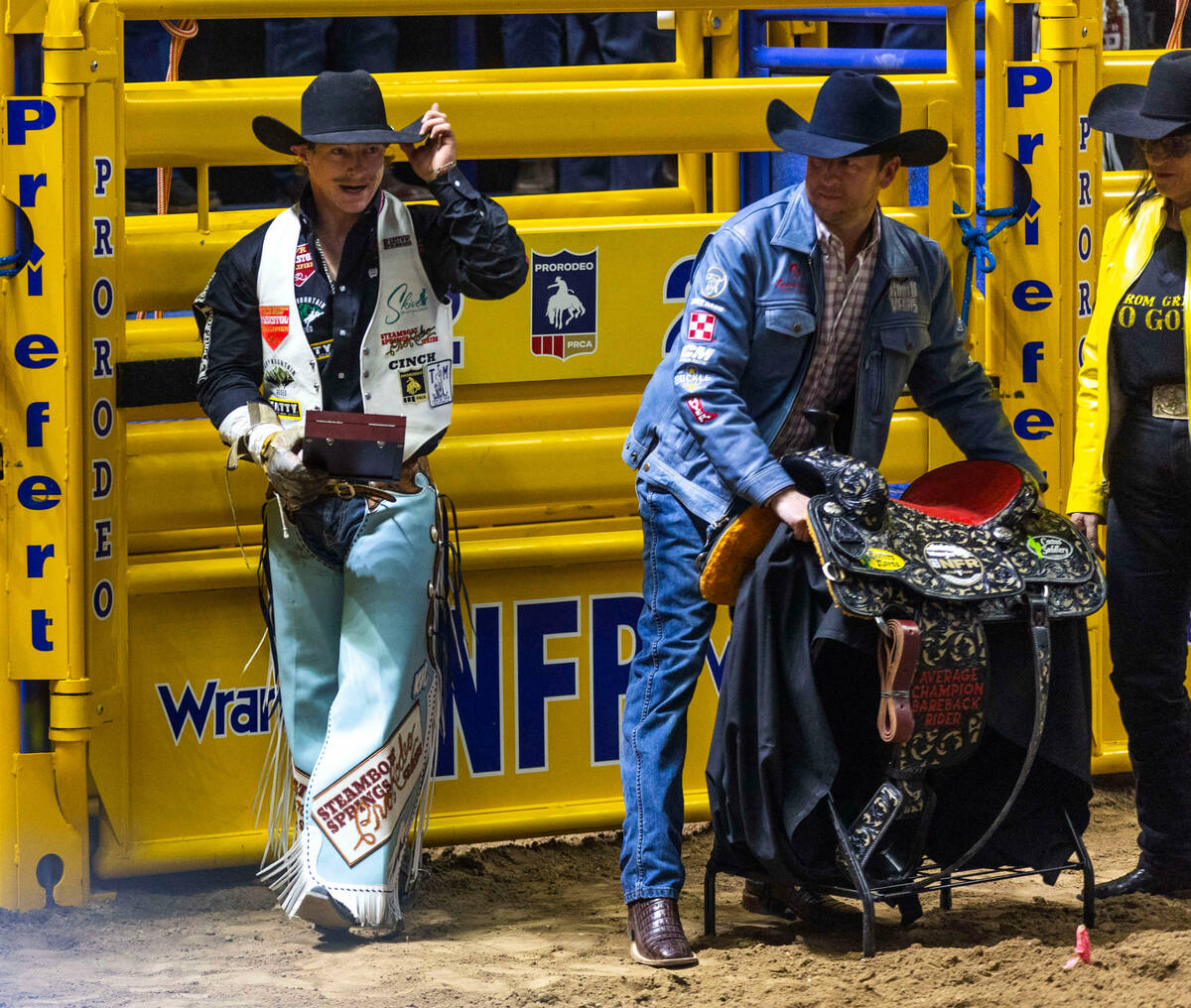 Keenan Hayes celebrates his PRCA World Championship with an award and saddle in Bareback Riding ...