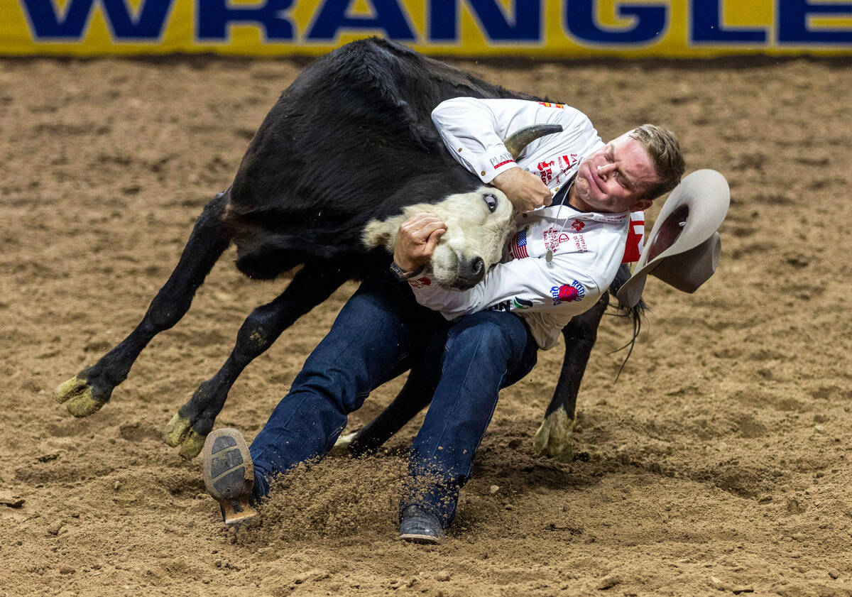 Dakota Eldridge works to take down his steer in Steer Wrestling during the final day action of ...