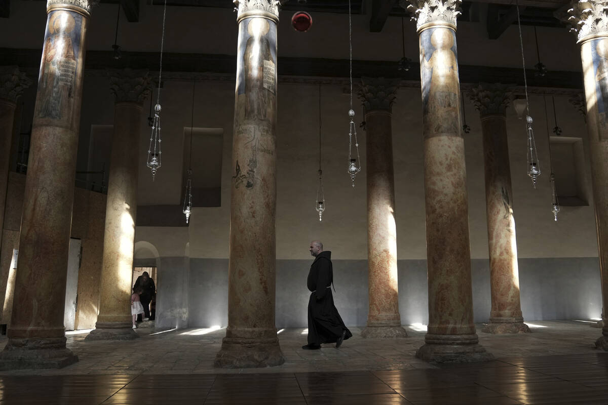 A priest walks at the Church of the Nativity, traditionally believed to be the birthplace of Je ...