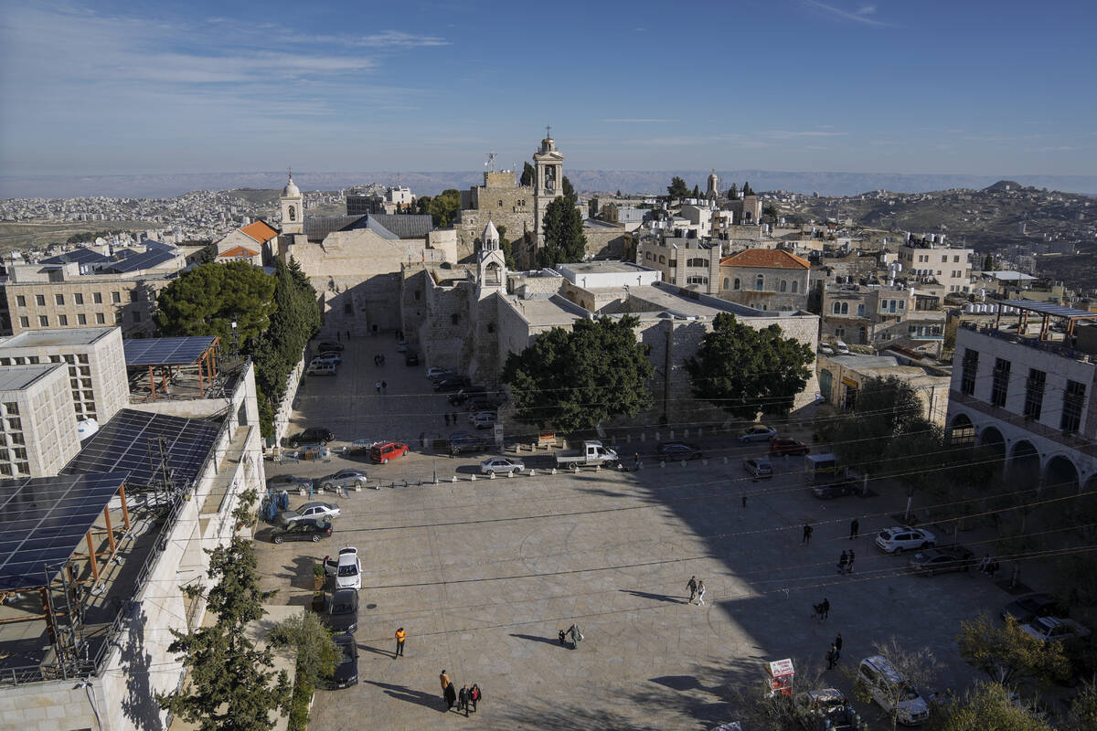 People walk in Manger Square, adjacent to the Church of the Nativity, traditionally believed to ...