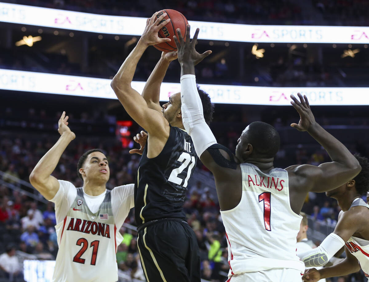 Colorado guard Derrick White (21) drives to the basket between Arizona center Chance Comanche ( ...