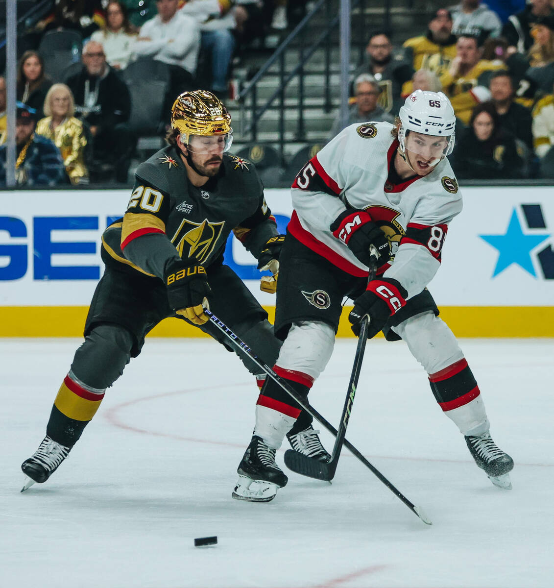 Ottawa Senators defenseman Jake Sanderson (85) hits the puck across the ice as Golden Knights c ...