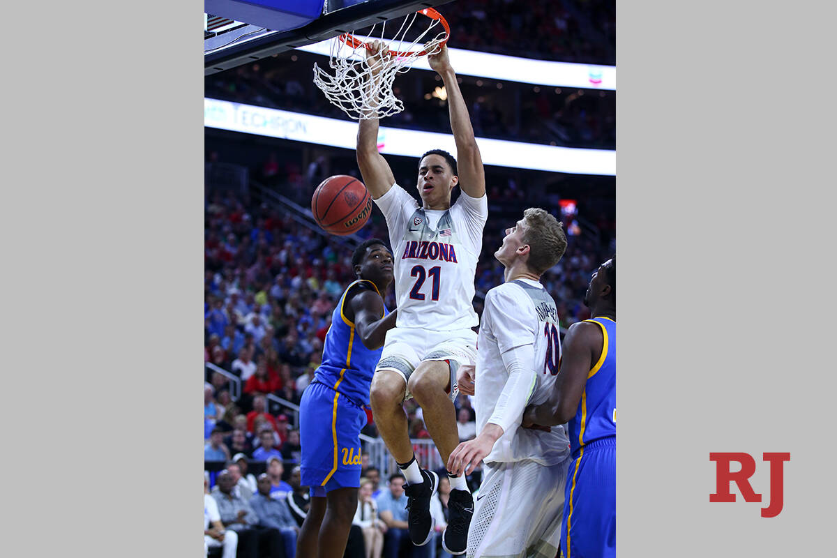 Arizona center Chance Comanche (21) dunks against UCLA during the Pac-12 Conference basketball ...