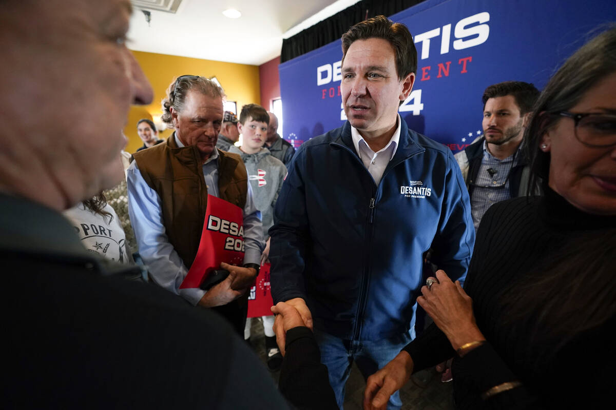 Republican presidential candidate Florida Gov. Ron DeSantis talks with audience members during ...