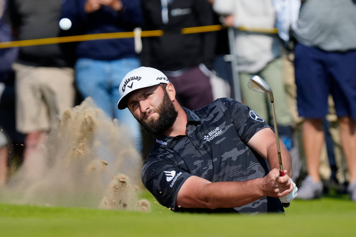 Spain's Jon Rahm hits out of a bunker on the 6th green on the first day of the British Open Gol ...