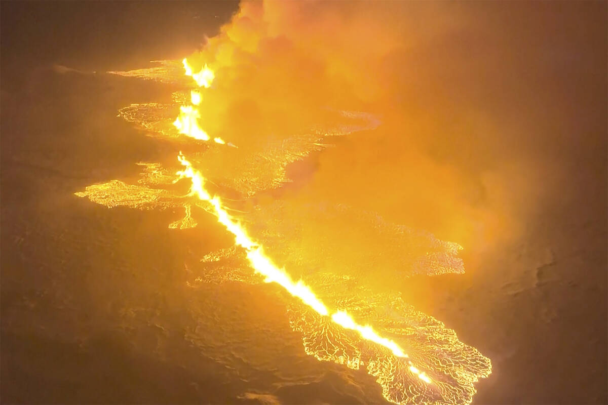 This image made from video provided by the Icelandic Coast Guard shows magma flow on a hill nea ...