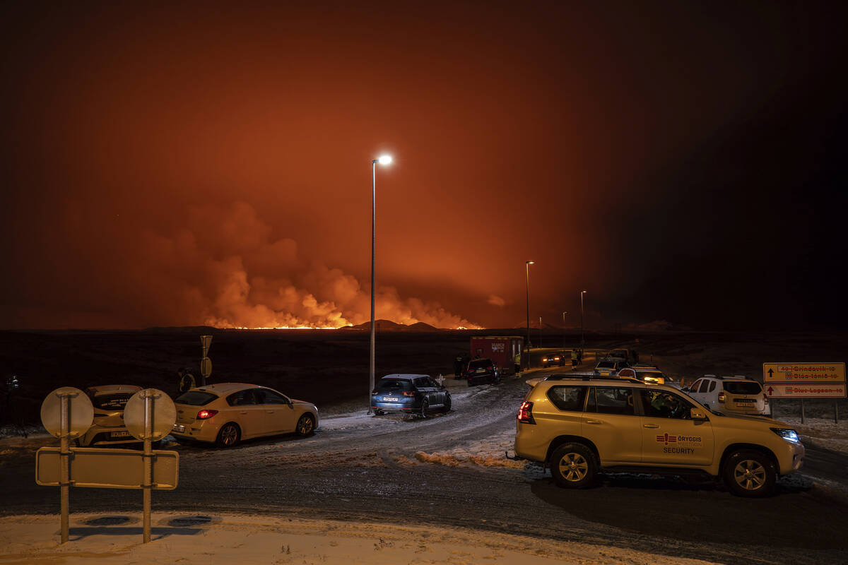 The road is blocked at the entrance of the road to Grindavík with the eruption in the back ...