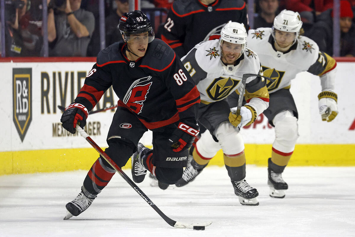 Vegas Golden Knights' William Carrier (28) controls the puck past Carolina Hurricanes' Jalen Ch ...