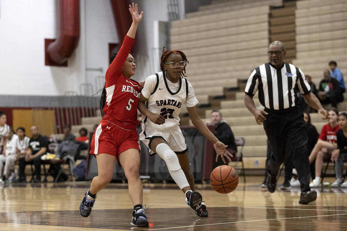 Cimarron-Memorial’s Dazani Graham (23) dribbles to shoot against Doral’s Ryann Ca ...