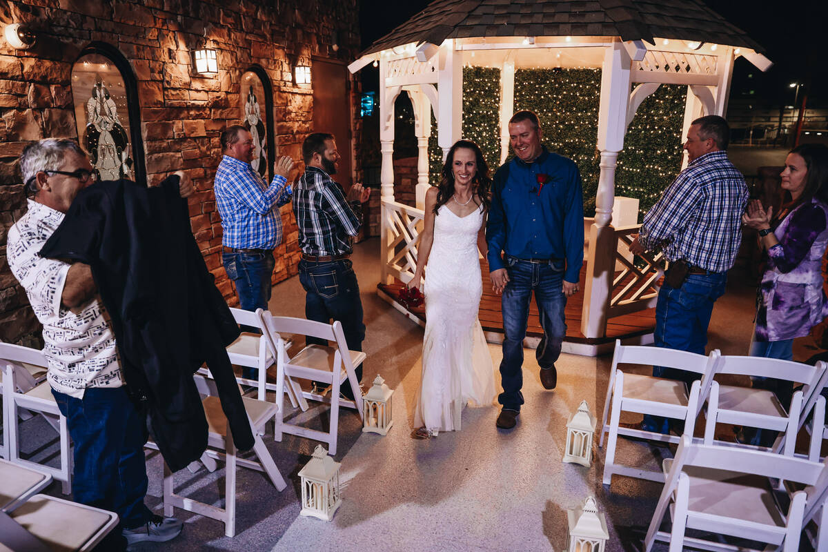 Kendra Smith, left, walks down the aisle with her husband, Keith Hagerman, during their wedding ...