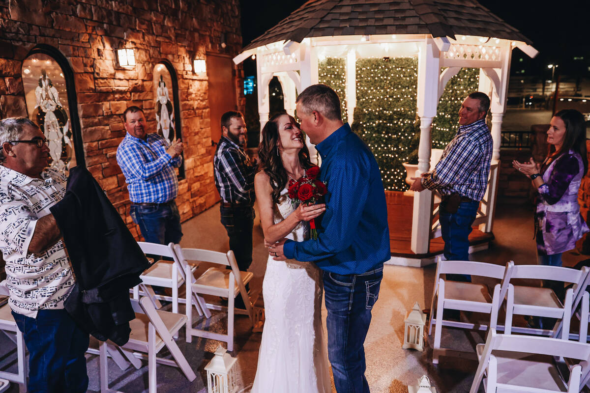 Kendra Smith, left, kisses her husband, Keith Hagerman, during their wedding ceremony at Vegas ...