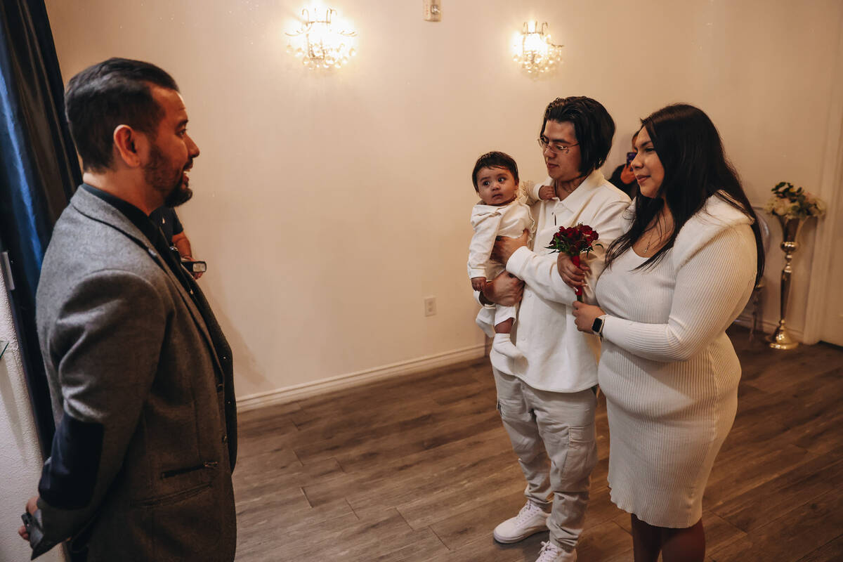 Rudolfo Corlew, left, and Natalie Mazariegos get married with their son, Michelangelo, in Corle ...