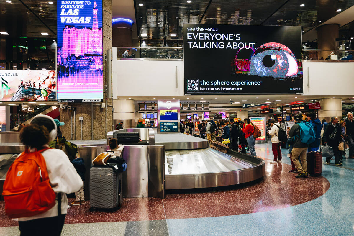 Travelers wait to pick up their bags at the baggage claim area at Harry Reid International Airp ...