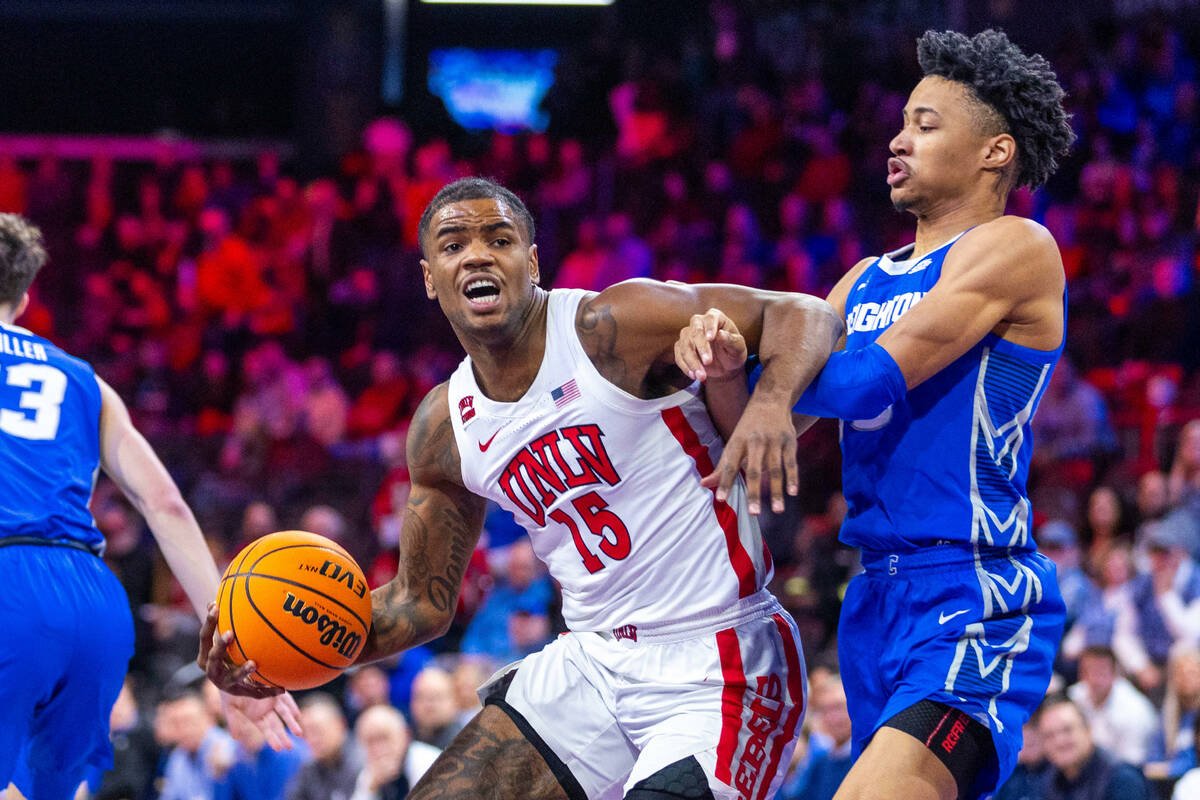 UNLV Rebels guard Luis Rodriguez (15) battles in the lane with Creighton Bluejays guard Trey Al ...